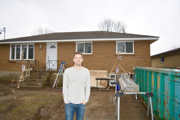 andrew standing in front of a property being renovated
